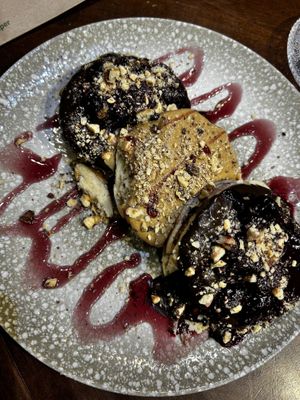 Vegan pancakes with bitter chocolate praline, peanut butter, red berries and red berry sauce &nuts   at Idees Art Cafe & Shop in Kastoria