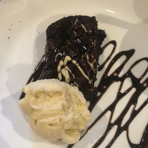 Brownie - ok. Bit chewy and packet chocolate sauce on top  at The Queen Inn in Cwmbran