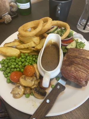 Steak with peppercorn sauce, chips, onion rings and salad  at The Queen Inn in Cwmbran