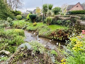 Pretty gardens and stream   at The Queen Inn in Cwmbran