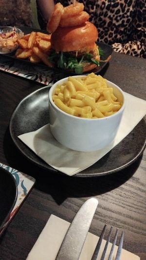 Mac and cheese side with wifes QFC burger in background. at The Queen Inn in Cwmbran