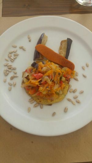 fried potato topped with mixed veggies and mock meat sausage  at Es Ginebro in Mallorca