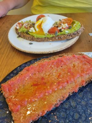 Tomato & oil on toast (minus chunk I ate!), with avocado and poached egg in background at Enxalao in San Sebastian