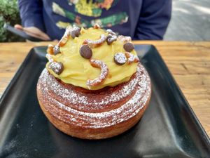 Cinnamon pastry topped with cream at Miga Vegana in Mexico City