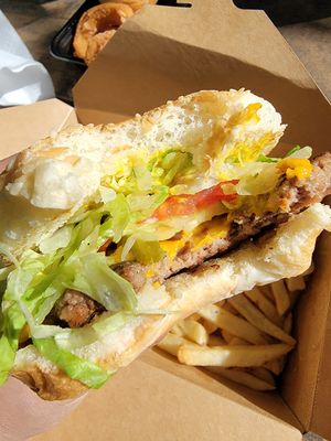 A view of the toppings and patty! Lettuce, tomato, pickles, grilled onion, "cheese" on a sesame bun!  at Plant Based Burger Company in Maple Heights