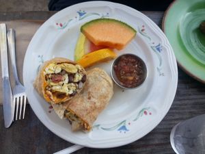 Breakfast burrito with veggie bacon, salsa, and fruit.  at The Den Cafe in Costa Mesa