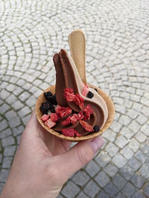 Small cup with natural and chocolate flavour side by side with dried blueberries and strawberries on top at Keep Bañana in Munich
