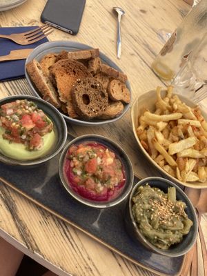 Guacamole, beetroot purée, aubergine dip, with croutons and chips   at Odil in Royan