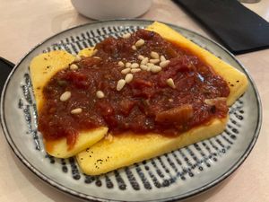 Polenta slices with melanzanni and tomato sauce  at Vegitalian in Salzburg