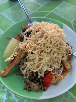 Ramen noodles on top of soy chicken, pork and rice at Jay Tamachad in Koh Samui
