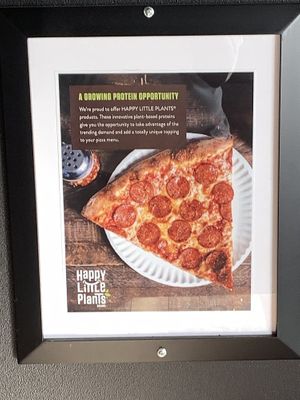 Article inside restaurant regarding plant based (vegan) meat option at University Pizza Company in Riverside