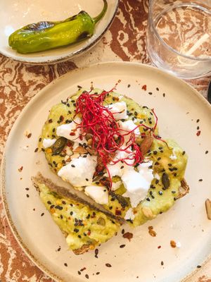 avo toast with 🌱 feta, almonds, pumpkin & sesame seeds  at Nowhere in Milan