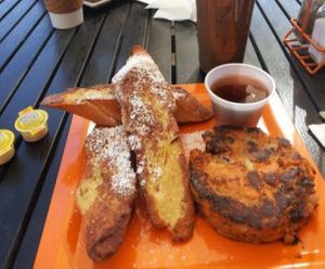 Vegan french toast & sweet potato hash w/ maple syrup, powdered sugar & earth balance on color-coded plates for veg*n dishes! Tasty soy cafe mocha. at Scramble in Phoenix