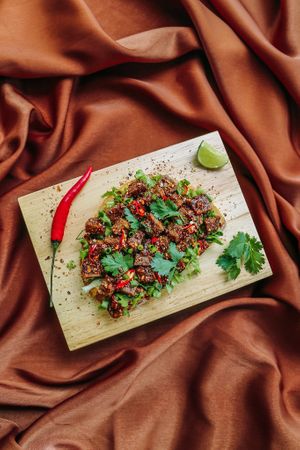 Nam Tok Mhoo Yang - Jackfruit-based protein cooked to crispy perfection. Tangy Thai flavours infused in our house-made “Jaew” Mayo will have your taste buds singing at Kappra Cafe in Bangkok