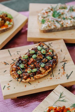 Tofu Teriyaki - Chonky slabs of firm tofu, marinated in sweet teriyaki, air-fried till golden. Paired with our house-made Spicy Island, edamame and strips of seaweed  at Kappra Cafe in Bangkok
