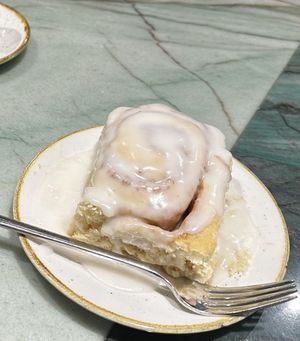 Cinnamon roll with way too much glaze  at Chimneys Friedrichshain in Berlin