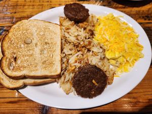 The Unusual (Beyond Meat sausage, Just Egg scramble with vegan cheese, hashbrowns, sourdough toast) at Seven Mile Cafe in Lewisville