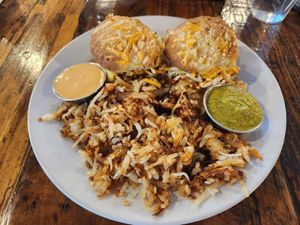 Berkeley Biscuit Sandwich (biscuit sandwich with Beyond vegan sausage, vegan cheese, and Just Egg), and a side of hashbrowns at Seven Mile Cafe in Lewisville