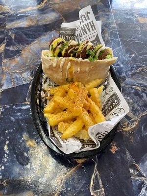 Authentic Peter falafel sandwich served with tasty spicy fries  at Taste of Tel Aviv in Houston