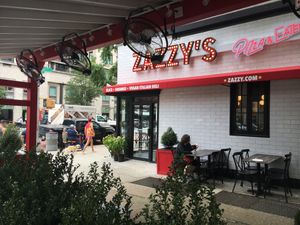 Side of pizza parlor: the sign says "vegan deli"--but the sign is 2 years old; they no longer have a vegan deli here at Zazzy's Pizza - Upper East Side in New York City