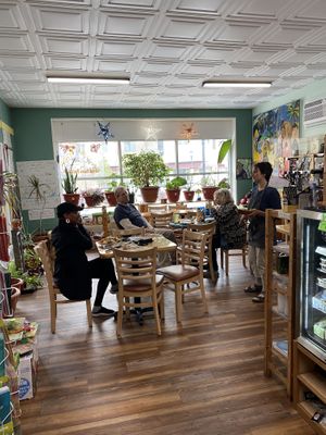 Patrons munching and eating and chatting at Arnold's Way Vegetarian Raw Cafe in Lansdale