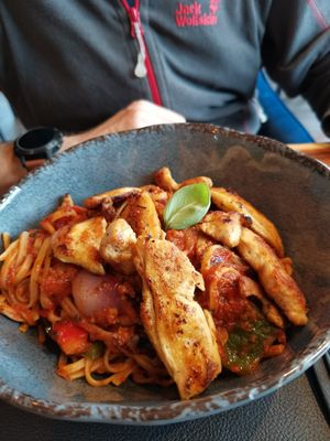 Pasta bavette with tomato chilli sauce enriched with shallots and vegan chicken at Central in Goslar