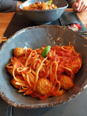 Pasta bavette with tomato sauce, vegan meatballs, refined with basil and olive oil.

 at Central in Goslar