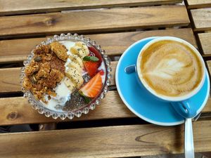 Vegan yogurt bowl and oat milk cappucino at MOYA brunch in Sevilla