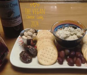 shareable herb cheese platter with Medjool dates, pistachios, seasoned almonds, red grapes, & crackers   at The Vegan Cheese Lady Cafe in Lafayette
