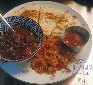 chipotle chickun quesadilla with a smear of guac, vegan salsa jack cheese, & diced tomatoes. served with spanish rice, black bean medley, & salsa at The Vegan Cheese Lady Cafe in Lafayette