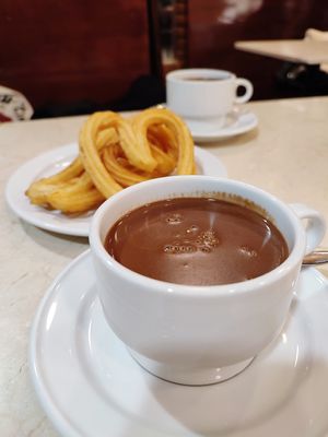 Hot chocolate with fresh, crispy churros at Chocolateria 1902 in Madrid