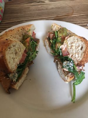 I added peppered Seiten, greens and tomatoes to the everything whole wheat bagel with pesto and sun-dried tomato cream cheese 🥓 🌱 🥯 🍅  at Grindcore House in Philadelphia