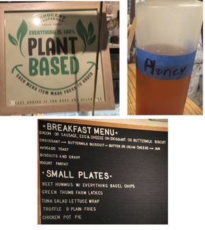 Confusing signs at Innocent Yesterday: one sign says "100% Plant Based," the other says "honey," the last doesn't specify that the food is vegetarian. at Innocent Yesterday in New York City