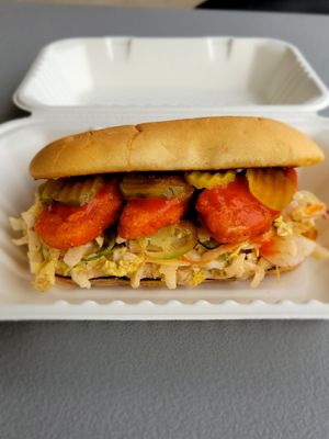 Spicy plantbased chicken,  Chipotle dressed napa cabbage slaw , dill pickles all on a sourdough roll. at The Lick in Vallejo
