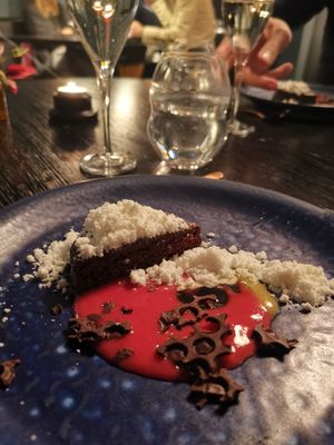 Vegan Dessert: chocolate cake with lingonberry sauce,  chocolate bits and dusted olive oil at Ravintola Jura in Helsinki