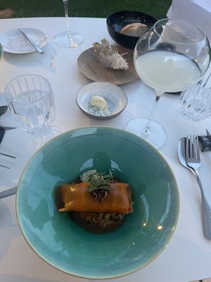 Smoked and marinated carrots meant to resemble salmon, with a vegetable filling. All that is served on a “bed” of rice and mushrooms and a miso sauce.   at Cuisine Intuitive in Marchin