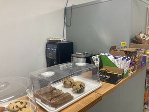 Green Heart Collective cafe counter with baked goods and snacks and coffee machine at Green Heart Collective in Gateshead