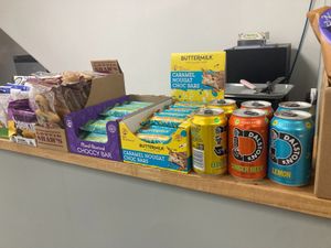 Vegan snack bars and cans of pop on Green Heart Collective cafe counter at Green Heart Collective in Gateshead