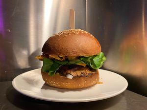 Mushroom Burger - Mushrooms fried with avocado, eggplant, marinated onion and cucumber, fresh tomato and salad, crunchy onion, black sesam, vegan Cheddar and curry-mustard sauce at El Forat in Barcelona