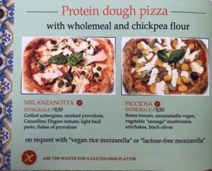 Zwei vegane Pizzen mit veganem Reis-Mozzarella, Vollkorn und Kichererbsen Teig  at Rossopomodoro in Rimini