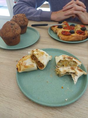 Banana and chocolate muffins, cheese and onion empanada, soya mince empanada, tomato and olive foccacia at Isla Vegana in Ushuaia
