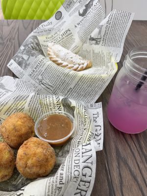 Papas rellenos, guava and cheese empanada, pea flour lemonade   at Cocina Plantosaurus in Charles Town