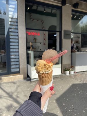 Salted caramel on top of peanut butter on vegan cone with vegan cookie wafer on top  at Fabrika in Tirana