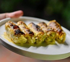 Traditional vegan baked cabbage rolls filled with rice, carrot, fresh herbs, topped with lemon & sesame paste dressing! at W Karytsi in Athens