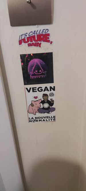 Two of the many stickers inside the bathroom at B.Better in Paris
