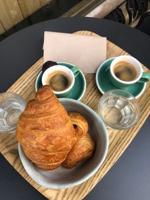(2) Petit-déjeuner menues = Espresso + croissant/pain au chocolat. 
Mini financier next to the left espresso at Land & Monkeys - Turenne in Paris