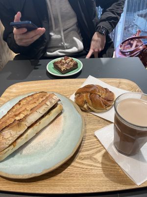 Mediterranean baguette, cinnamon roll, oat milk hot choc and brownie 🥹  at Land & Monkeys - Turenne in Paris