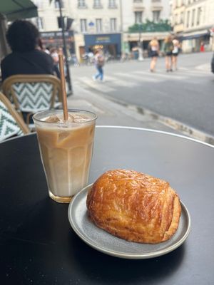 Iced latte and pain au chocolat watching the city go by. at Land & Monkeys - Turenne in Paris