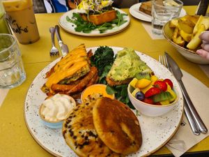 Mega Vegan Brunch Plate, avo toast, orange and choc pancakes, vegan cream, chickpea omelette, fresh fruit, sweet potato fries, spinach at Shake Café in Florence
