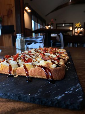 Flat bread of the day made vegan (Balsamic vinaigrette, sun dried tomatoes, and daiya cheese) my fav appetizer now!   at Alcona Brew Haus in Harrisville
